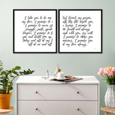 two framed art prints on the wall above a dresser with flowers and a potted plant