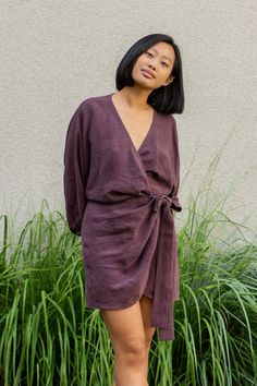 Woman wearing Linen wrap tulip hem dress Daisy in shadow purple color V-neck Tie Waist Dress For Daywear, Fitted V-neck Belted Dress For Daywear, Chic V-neck Belted Dress For Day Out, Spring V-neck Belted Dress For Date Night, Belted V-neck Mini Dress For Day Out, Chic V-neck Midi Dress With Tie Fastening, Daywear Mini Dress With Tie Fastening, Spring V-neck Belted Dress, Belted V-neck Daywear Dresses