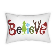 a white pillow with the words believe and santa clause in red, green, yellow and blue