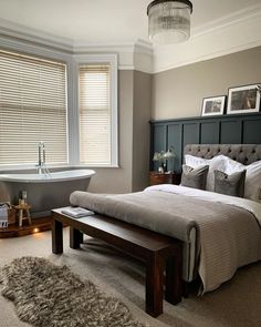 a bedroom with a large bed and a bathtub