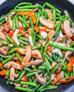 chicken, green beans and peppers in a skillet