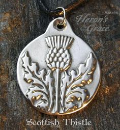 Scottish Thistle The national symbol of Scotland. The thistle is a tough, strong, and robust plant. It grows in places where others can't survive. One finds it to be very beautiful yet discovers it's sharp thorns for protection. One might say beautiful but fierce. To wear a thistle brings protection and inner strength and helps honor one's strong roots with pride.  [Size: aprox. 1-1/16" across]  Comes strung on Black Cotton Cord - adjustable length.  Poured by hand in America, solid Britannia, an ancient lead free pewter. Thistle Wedding Flowers, Thistle Wedding, Thistle Necklace, National Flower, Celtic Necklace, National Symbols, Scottish Thistle, Pewter Pendant, Henna Tattoo Designs