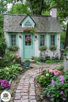 a small white house with blue doors and windows, surrounded by greenery and flowers