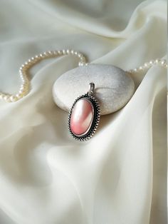 This 925 Sterling Silver pendant is purely handmade and natural Pink Pearl is used as gemstone. *chain is not included* Pearl: * symbol of innocence and purity * brain power * spirituality * harmonious relationships * supports sleep * enhances skin beauty * bright eyes * peaceful mind * decisiveness * confidence * emotional balance * deflects negativity ☆June birthstone Silver: * healing * balanced emotions * psychism * peace * raises sensitivity * expands the psychic awareness * protects from n Delicate Handmade Oval Jewelry, Oval Pendant Necklaces With Cabochon For Wedding, Oval Pendant Cabochon Necklace For Wedding, Oval Cabochon Pendant Necklace For Weddings, Wedding Necklaces With Oval Cabochon Pendant, Delicate Sterling Silver Jewelry With Natural Stones, Delicate 925 Stamped Jewelry For Gift, Silver Necklace With Natural Stones For Weddings, Oval Cabochon Pendant Jewelry For Wedding