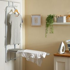 an ironing board with clothes hanging on it