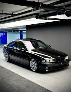 a black car parked in a parking garage