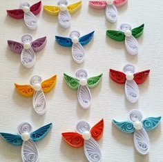 many different colored hair clips on a white surface