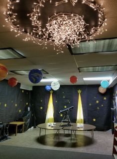 an empty room with lights and decorations on the ceiling