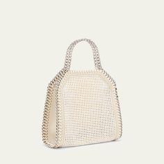 Stella McCartney "Falabella" mesh vegan leather (polyurethane) and nylon tote bag with embroidered logo  Chain top handles with logo charm  Chain shoulder/crossbody strap Can be worn as a top handle, shoulder, or crossbody bag  Open top with magnetic closure  Interior, one slip pocket  Approx. 6.9"H x 7.1"W x 2.4"D Item Weight (Lbs.): 1.3 Spot clean Made in Italy Vegan Leather Tote Bag, Stella Mccartney Falabella, Stella Mccartney Bag, Chain Top, Vegan Leather Tote, Nylon Tote Bags, Charm Chain, Nylon Tote, Open Top