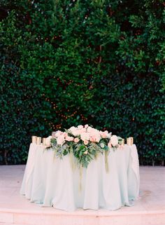 an image of a table with flowers on it and the text romantic + whimsical garden wedding