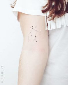 a woman's arm with a small star tattoo on it