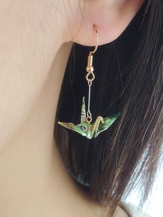 FOR BUNDLE DEALS:  https://artichouxcanada.etsy.com/listing/1633754962 https://artichouxcanada.etsy.com/listing/1633725324 Introducing our stunning handmade Origami Crane Earrings, meticulously crafted with the finest and most vibrant Japanese Yuzen/Chiyogami washi paper. These delightful earrings feature exceptional silver and gold plated hardware materials, adding a touch of elegance to the overall design.  With a wonderful range of captivating colors and patterns to choose from - including green, purple, yellow, pink, and blue - you're sure to find the perfect pair that complements your unique style. DIMENSIONS - Length from Earlobe: 3.5 cm (1.37 in) - Width (Wing to Wing): 2.8 cm (1.1 in) MATERIALS - Japanese Yuzen/Chiyogami washi paper - 14K Silver plated connector  - 14K Gold plated Origami Crane Earrings, Paper Crane Earrings, Valentines Gift For Friends, Origami Candy, Unique Origami, Origami Lily, Crane Earrings, Earrings Paper, Origami Earrings