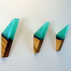 three pieces of wood with green paint on them