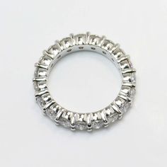 a white gold diamond ring on a white background