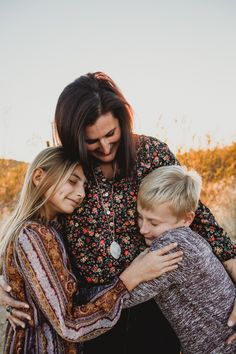 two women and a boy hugging each other