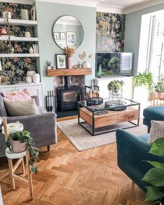 a living room filled with furniture and a fire place next to a wall mounted tv