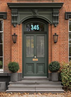 a green door with the number 340 on it in front of a red brick building