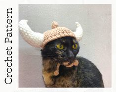 a cat wearing a crochet hat with horns