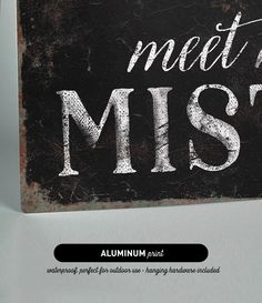 a black and white sign that says meet me at the mist on it's side