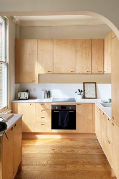 a kitchen with wooden cabinets and white counter tops