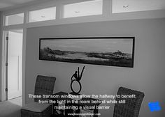 there is a black and white photo hanging on the wall above a dining room table