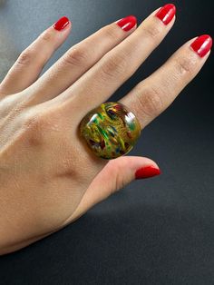 Adorn your fingers with the vibrant beauty of Handblown Glass Rings, meticulously crafted in Malta. Each ring is a unique work of art, featuring smooth, rounded edges for a comfortable fit. The rich, bold colors make these rings truly stand out, adding a touch of individuality to any outfit. Perfect for those who appreciate finely crafted jewelry, these glass rings are as durable as they are stunning.    Sizes are all in US metrics, shown in the first picture  Weight : 8g - 13g    The order of the variations is left to right, top to bottom. Ex. the ring in upper left corner is no.1, the ring in downer right corner is no.23    For each sale we plant a tree :) Glass Ring, Glass Rings, Crafted Jewelry, Slovakia, Hand Blown Glass, Malta, Rings Statement, One Pic, Bold Colors