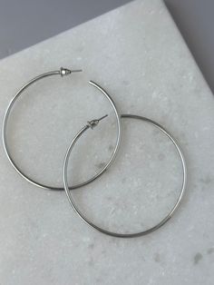 Expertly crafted with classic silver, the Mona Hoops-Silver add timeless elegance to any outfit. These open hoops are perfect for everyday wear and can easily transition from day to night. Elevate your style effortlessly with these versatile and stylish earrings! Hoops Silver, Stylish Earrings, Stylish Earring, Day To Night, To Night, Elevate Your Style, Timeless Elegance, Your Style, Everyday Wear