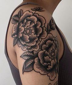 a woman's arm with black and white flowers on it