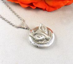 This twilight inspired locket necklace is 30 inches long. Vintage style silver round locket which has engraved floral patterns on the sides; is decorated with a detailed antique finished silver setting, and pewter wolf charm. Pendant is hanging from a antique silver trinity link. I have finished the necklace with silver chain and silver lobster clasp. Locket is 32mm in size. It opens sideways, and has room for two photos! Please note: I DO NOT DO ENGRAVING OR INSERT PICTURES! Thanks for looking: Silver Locket Necklace With Antique Finish As Gift, Bohemian Silver Locket Necklace With Round Pendant, Silver Locket Necklace With Antique Finish, Silver Round Locket Necklace With Antique Finish, Bohemian Silver Locket Necklace, Collectible Silver Metal Locket Necklace, Silver Bohemian Engraved Locket Necklace, Silver Antique Finish Locket Necklace, Ornate Silver Locket Necklace For Gift