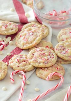 peppermint white chocolate chip cookies and candy canes on a table with pink border