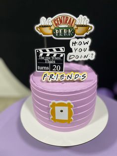 there is a pink cake with some signs on it