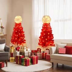 two christmas trees decorated with lights and presents