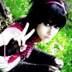 a young woman with black hair making the peace sign