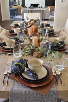 the table is set with dishes and place settings