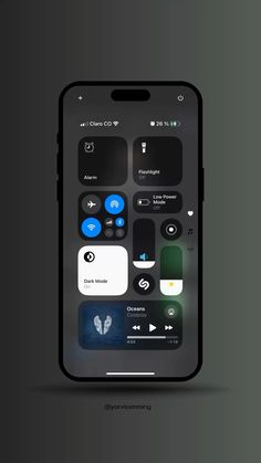 an iphone with icons on the screen and in the back ground, there is a dark background