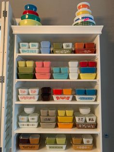 the shelves are filled with bowls and containers