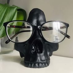 a black skull wearing glasses on top of a table