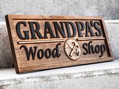 a wooden sign with the words grandpa's wood shop on it and a horse head