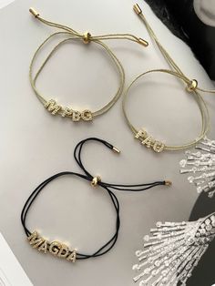 This Custom Cord Bracelet offers you a unique and stylish way to express your individuality. Crafted with beautiful zirconia gold plated letters and adjustable cords in both black and gold, it's the perfect accessory to make an unforgettable statement. Carrie Necklace, Bracelet Cordon, Heart Hoop Earrings, Clover Necklace, Cord Bracelet, Black Necklace, Cord Bracelets, Letter Necklace, Heart Bracelet