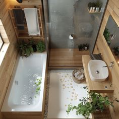 an aerial view of a bathroom with a bathtub, sink and plants in it