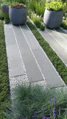 two large planters sitting next to each other on top of a grass covered field