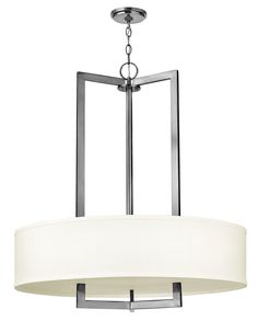 a chandelier with a white drum light hanging from it's center pole