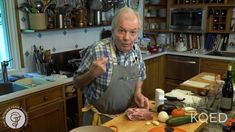 an old man is preparing food in the kitchen