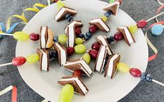 a white plate topped with lots of cake next to colorful candies and streamers