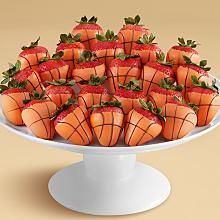 strawberries are arranged in the shape of basketballs on a cake platter, ready to be eaten