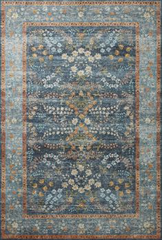 a blue rug with an orange border and floral design on the bottom, in front of a