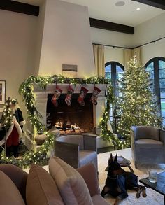 a living room filled with furniture and christmas decorations