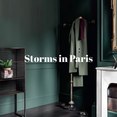 a room with green walls and a coat rack in the corner that says storm in paris