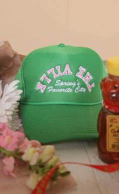 Spring's favorite city: Fayetteville, AR! The Farmer's Market, baseball games at Baum Walker, tulips blossoming on The Square! It's the best time of the year! This green trucker hat features a trendy pink embroidered graphic - perfect for everyone who loves "The Ville." ALL HATS ARE FINAL SALE! Spring Trucker Hat, One Size Fits Most, Trendy Spring Trucker Hat Baseball Cap, Trendy Spring Trucker Hat, Retro Curved Bill Hats For Spring, Retro Letter Print Baseball Cap For Spring, Trendy Trucker Hat Baseball Cap For Spring, Green Spring Trucker Hat, Green Trucker Hat For Spring, Green Trucker Hat For Spring, One Size Fits Most