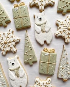 decorated cookies are arranged in the shape of christmas trees, bears and snowflakes